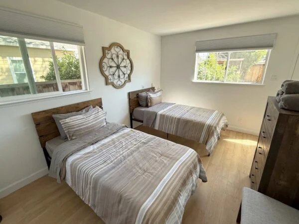 A bright, comfortably furnished shared bedroom