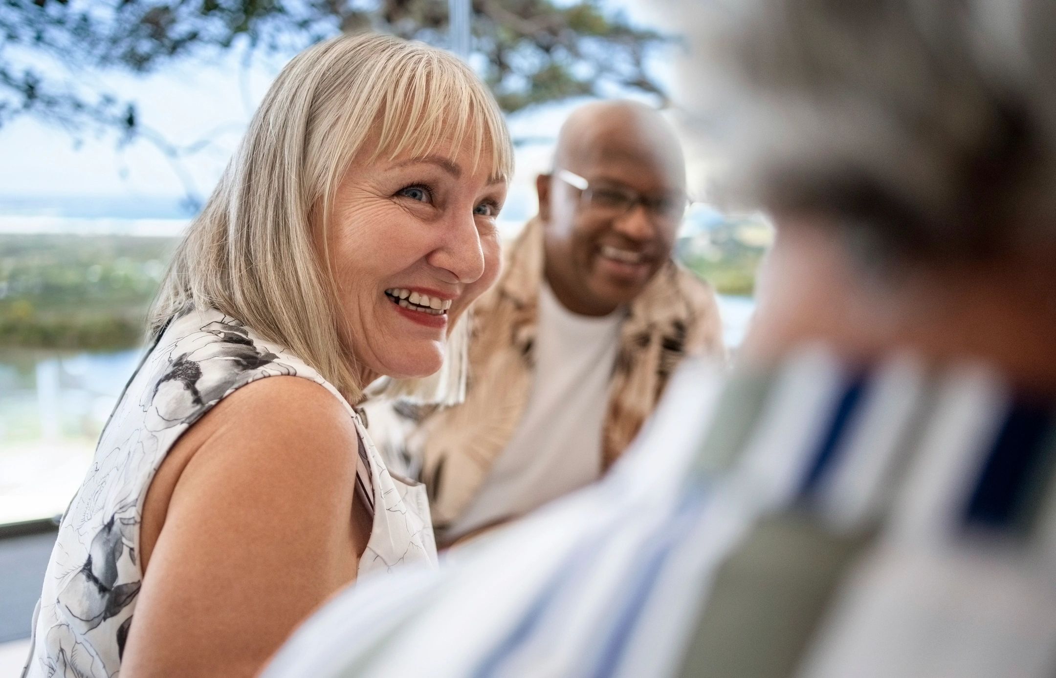 Older adults laughing together around a table